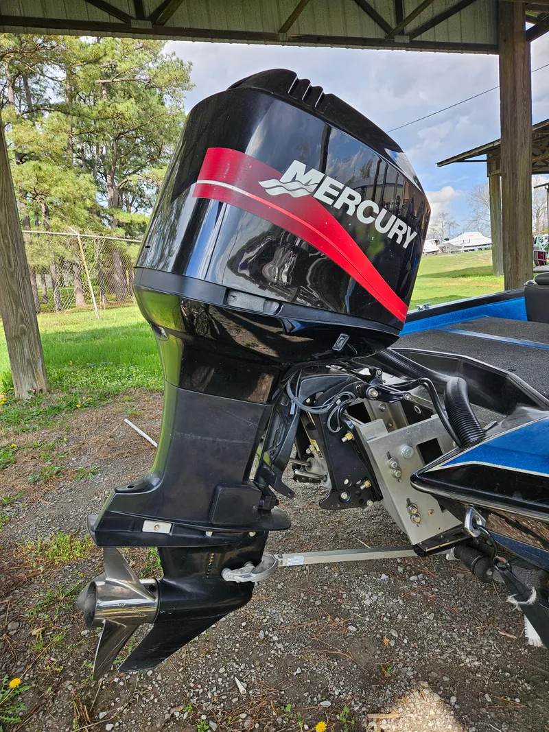 Slide: The Image of 1993 Bullet 20XD boat with Mercury outboard motor under a shelter. - 15