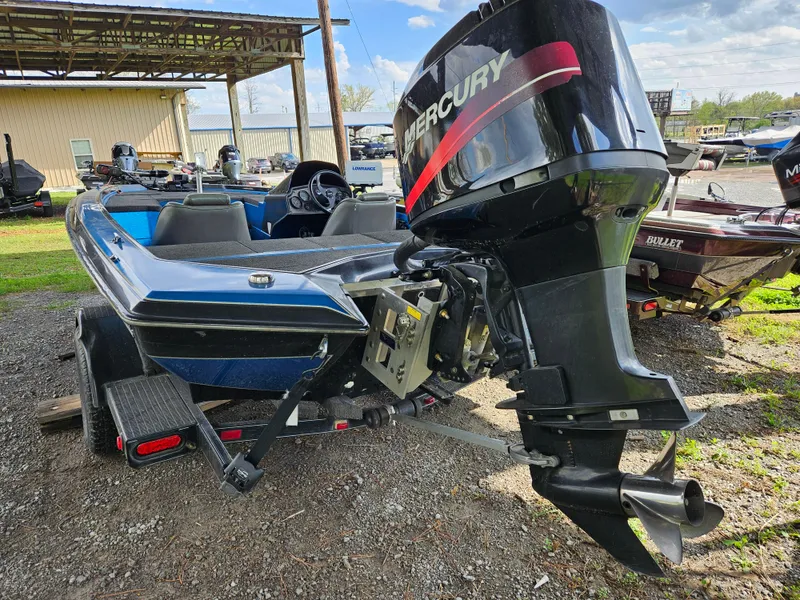 Slide: The Image of 1993 Bullet 20XD boat with Mercury outboard motor, parked on a trailer. - 17