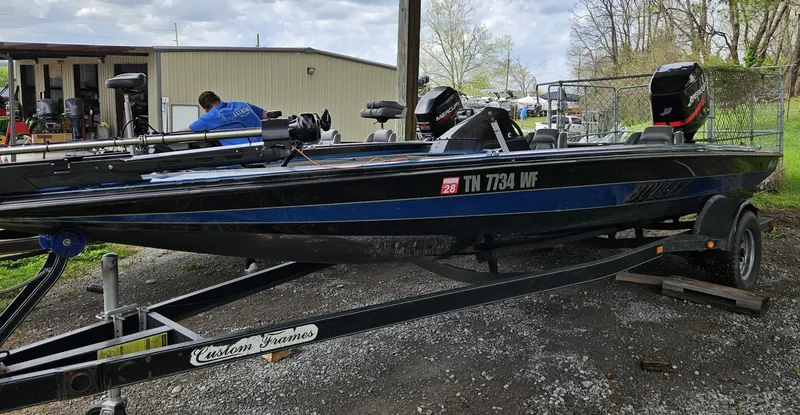 Slide: The Image of 1993 Bullet 20XD boat on trailer, parked outdoors near a building. - 3