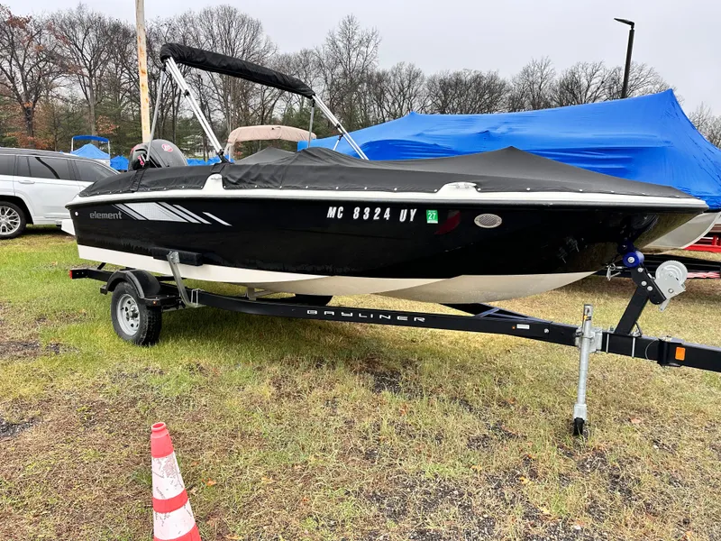 Slide: The Image of 2023 Bayliner Element 18 Deck Boat on trailer, parked outdoors. - 6