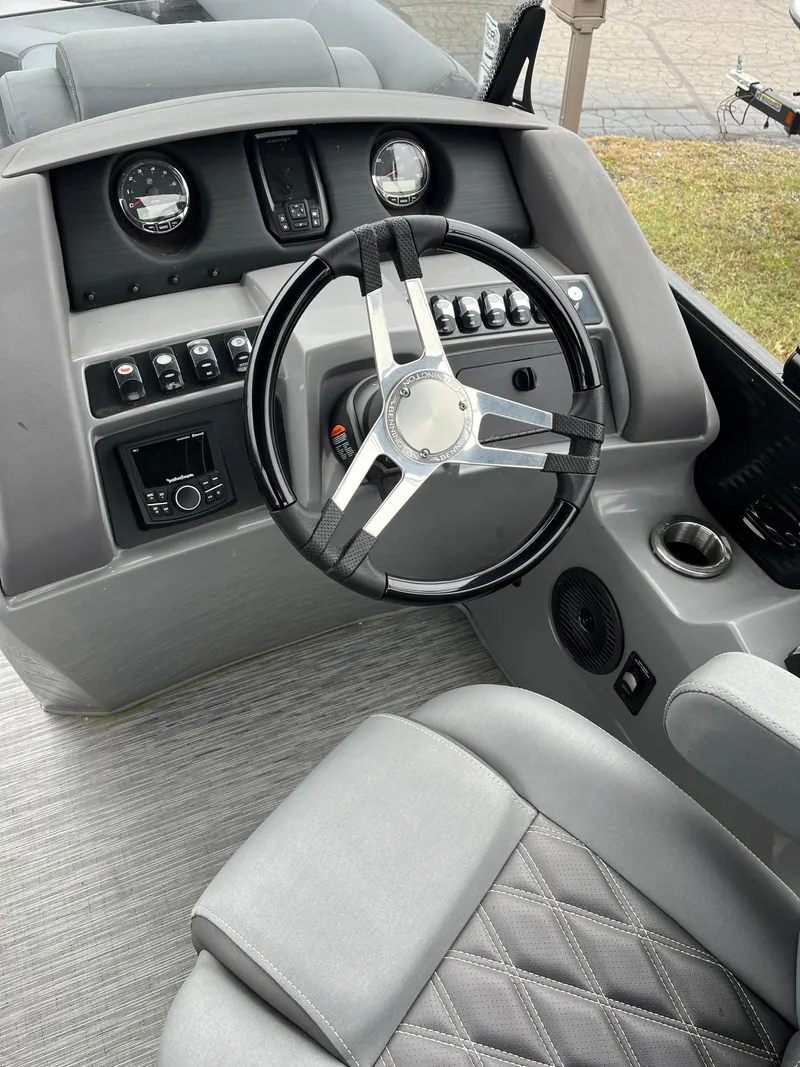 Slide: The Image of 2022 Bennington LXS SPORT 24 LXSB boat dashboard with steering wheel and controls. - 13