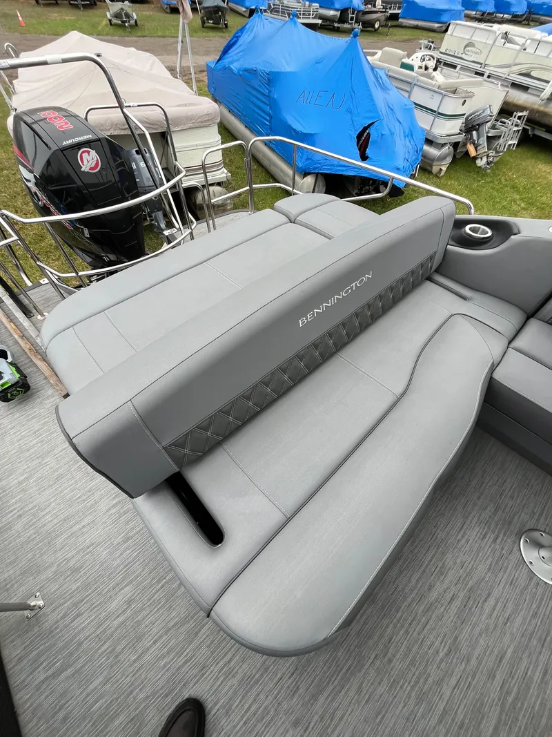 Slide: The Image of 2022 Bennington LXS SPORT 24 LXSB boat with gray seating and sleek design. - 9
