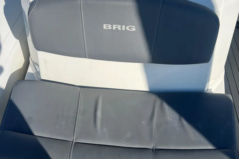 Slide: The Image of 2022 Brig Eagle 8 boat seat with logo, featuring gray upholstery. - 10
