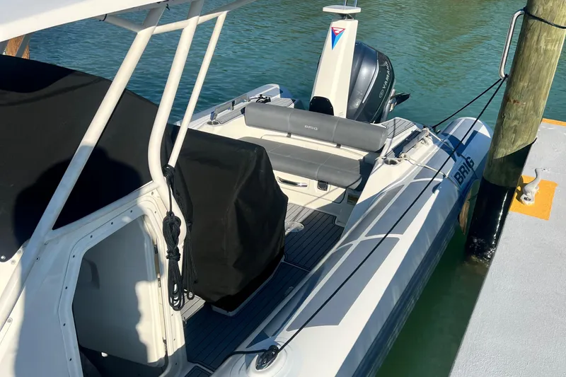 Slide: The Image of 2022 Brig Eagle 8 boat docked, featuring sleek design and modern outboard motor. - 11