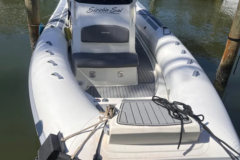 Slide: The Image of 2022 Brig Eagle 8 inflatable boat docked, featuring a sleek design and comfortable seating. - 13