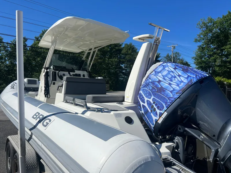 Slide: The Image of 2022 Brig Eagle 8 boat with custom engine cover, parked on a trailer. - 15