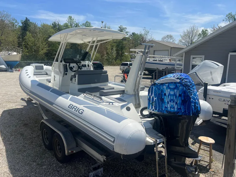 Slide: The Image of 2022 Brig Eagle 8 boat on trailer, parked outdoors, with a covered outboard motor. - 19