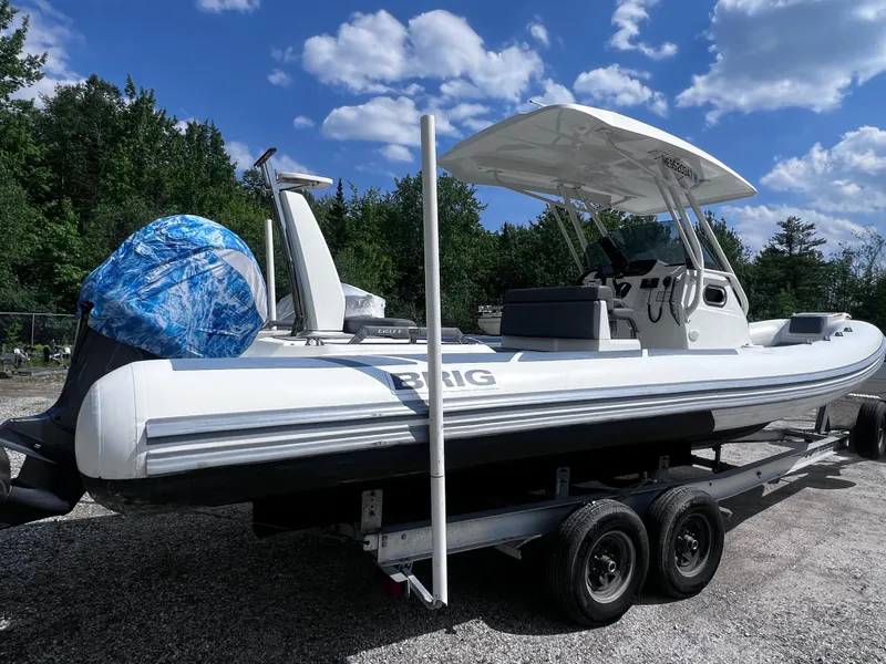 Slide: The Image of 2022 Brig Eagle 8 boat on trailer under blue sky and trees. - 26