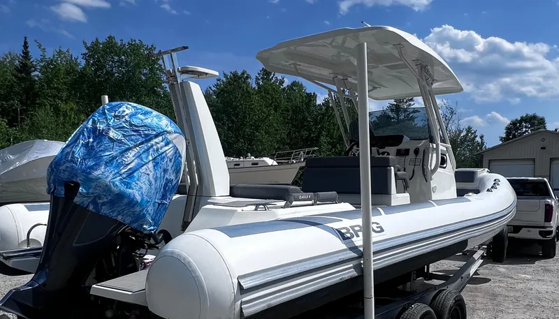 Slide: The Image of 2022 Brig Eagle 8 boat on trailer, outdoors under blue sky. - 27