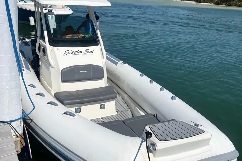 Slide: The Image of 2022 Brig Eagle 8 boat docked on calm water, featuring sleek design and comfortable seating. - 3