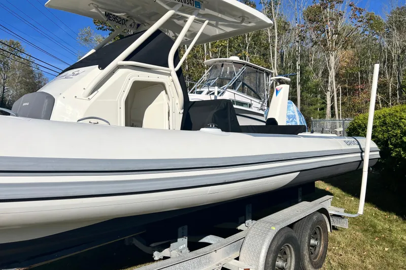 Slide: The Image of 2022 Brig Eagle 8 boat on trailer, parked outdoors, under clear blue sky. - 30