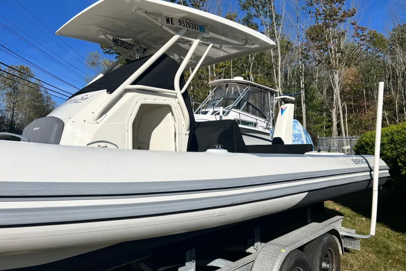 Slide: The Image of 2022 Brig Eagle 8 boat on trailer, white hull, outdoor setting, clear sky. - 31
