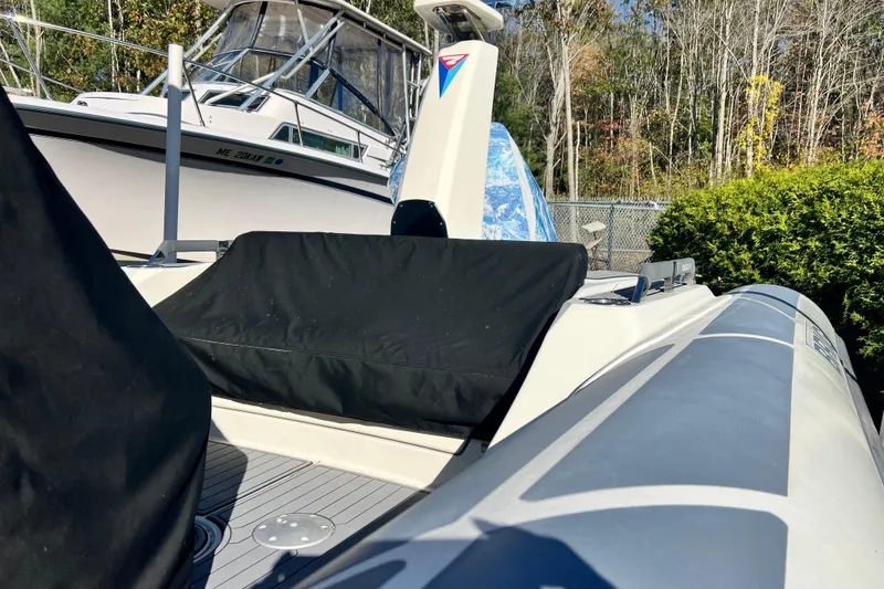 Slide: The Image of 2022 Brig Eagle 8 boat docked, featuring sleek design and covered seating area. - 34