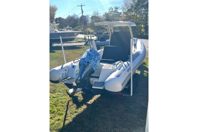 Slide: The Image of 2022 Brig Eagle 8 inflatable boat on grass, featuring a covered outboard motor. - 39