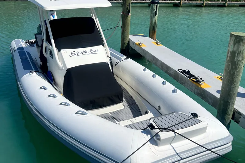 Slide: The Image of 2022 Brig Eagle 8 boat docked in clear turquoise water. - 4