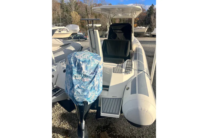 Slide: The Image of 2022 Brig Eagle 8 inflatable boat with covered outboard motor, parked outdoors. - 42