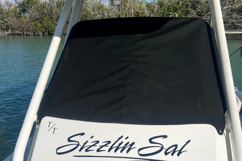 Slide: The Image of 2022 Brig Eagle 8 boat named "Sizzlin Sal" docked by the water. - 5