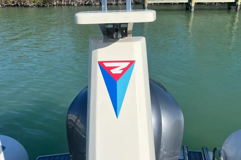 Slide: The Image of 2022 Brig Eagle 8 boat detail with logo, docked on calm water. - 6