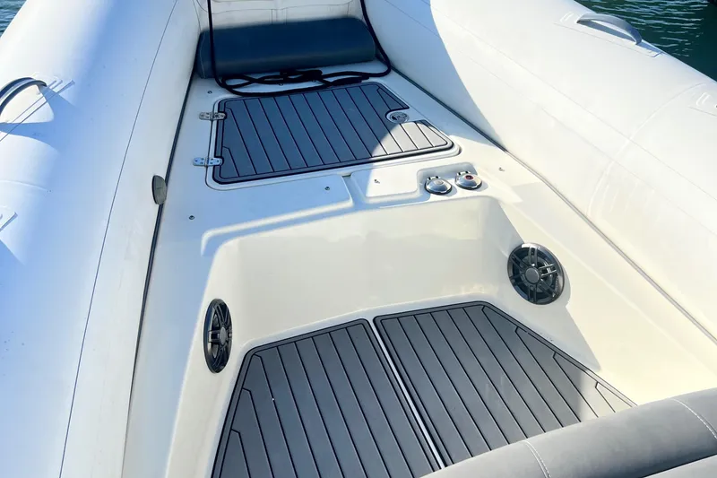 Slide: The Image of 2022 Brig Eagle 8 boat interior with cushioned seating and deck details. - 7