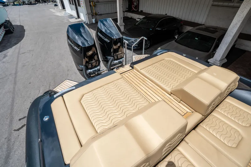 Slide: The Image of 2023 Ribco Seafarer 36 X boat with twin Mercury engines and beige cushioned seating. - 13
