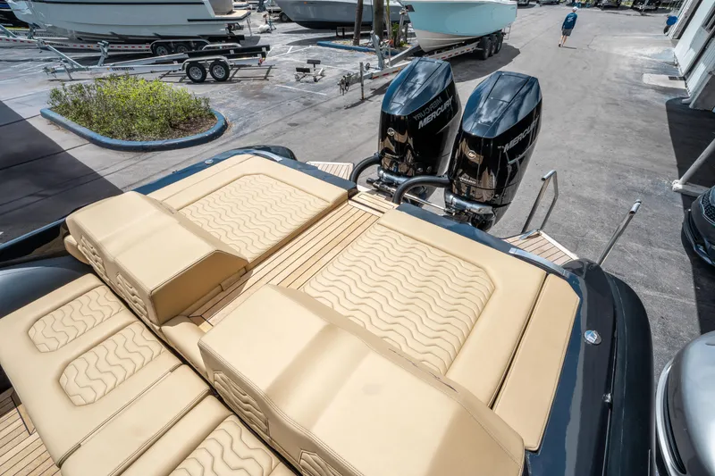 Slide: The Image of 2023 Ribco Seafarer 36 X with twin engines and tan seating, docked at a marina. - 14