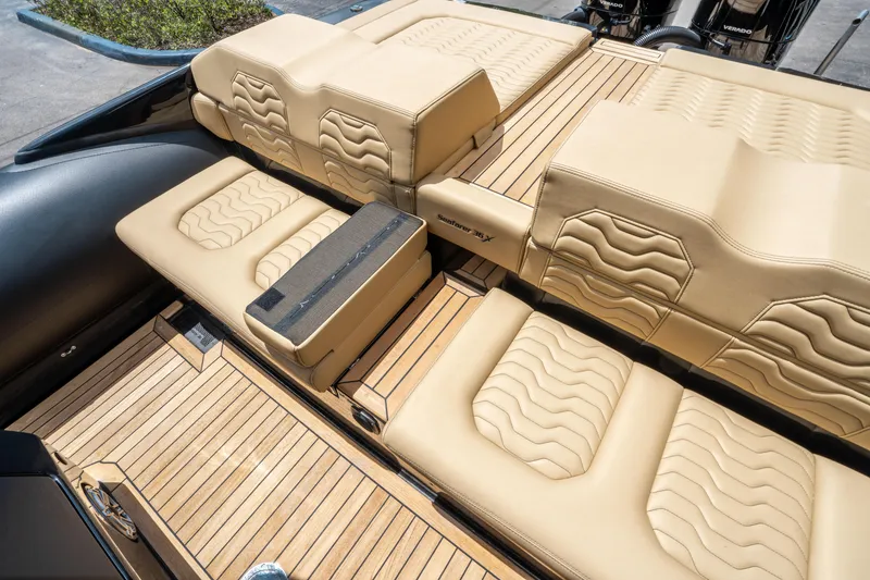 Slide: The Image of Luxurious seating on 2023 Ribco Seafarer 36 X boat with beige upholstery and wood accents. - 18