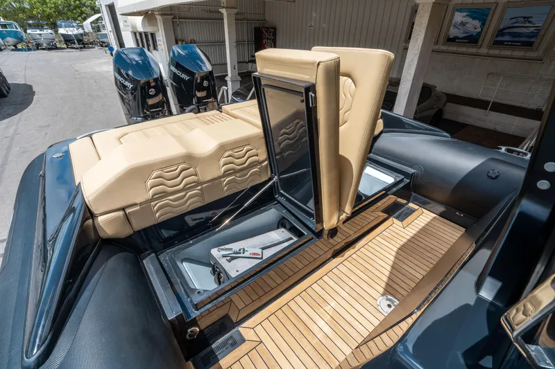 Slide: The Image of 2023 Ribco Seafarer 36 X boat interior with tan seating and wooden deck. - 19