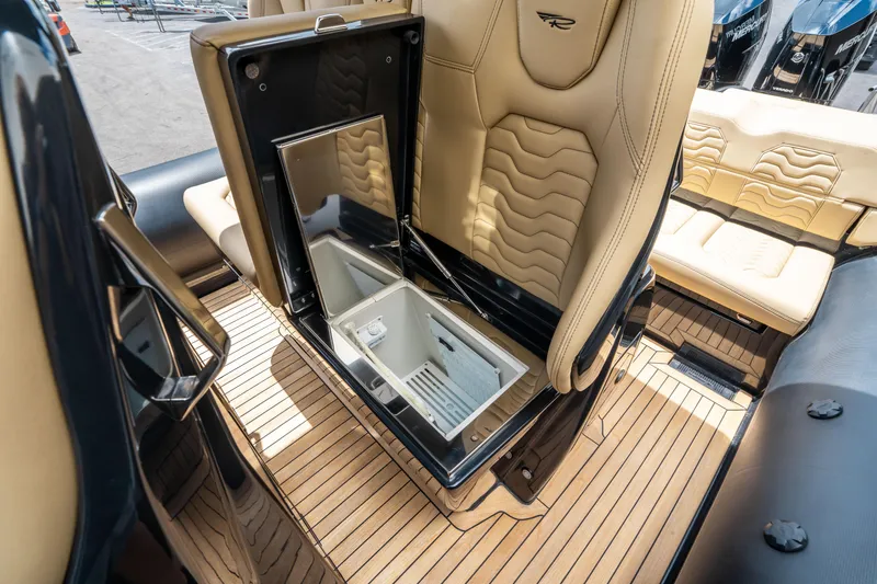 Slide: The Image of 2023 Ribco Seafarer 36 X interior with open storage compartment and beige seating. - 30