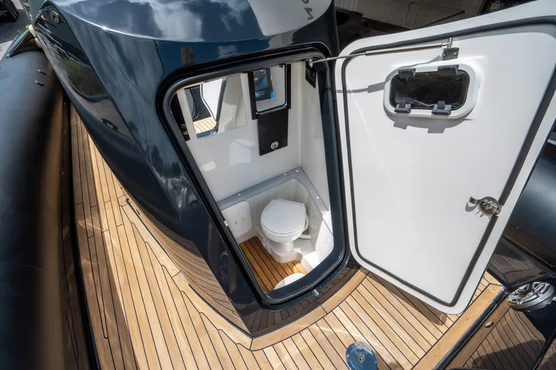 Slide: The Image of 2023 Ribco Seafarer 36 X boat with open bathroom door on teak deck. - 40