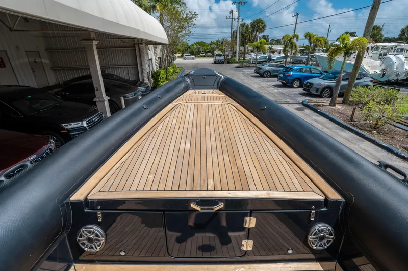 Slide: The Image of 2023 Ribco Seafarer 36 X boat with sleek wooden deck, parked outdoors. - 42