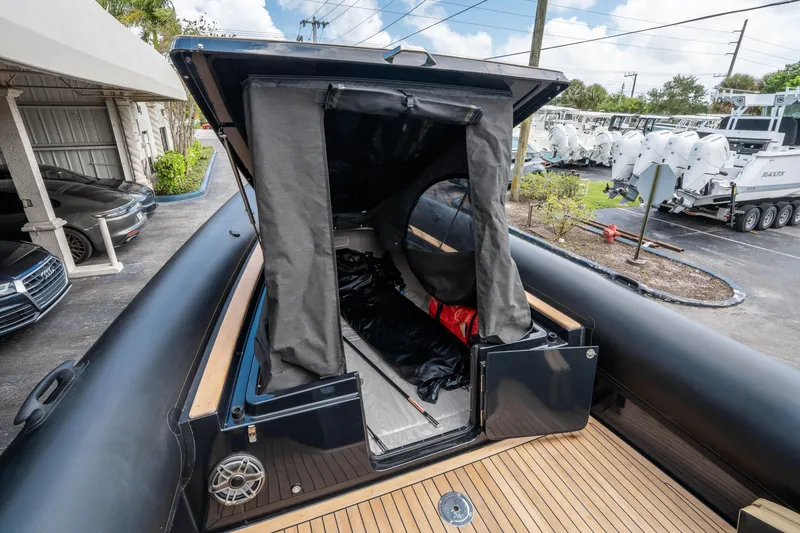 Slide: The Image of 2023 Ribco Seafarer 36 X boat with open storage compartment, docked outdoors. - 43