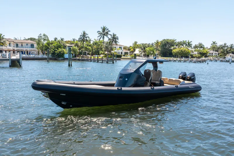 Slide: The Image of 2023 Ribco Seafarer 36 X boat cruising on a sunny day near waterfront homes. - 5