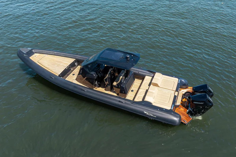 Slide: The Image of 2023 Ribco Seafarer 36 X boat on water, featuring sleek design and dual outboard engines. - 9