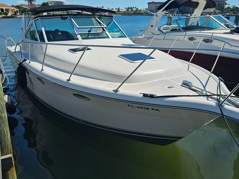 Slide: The Image of 2000 Tiara Yachts 3100 Open docked in marina, sunny day. - 0