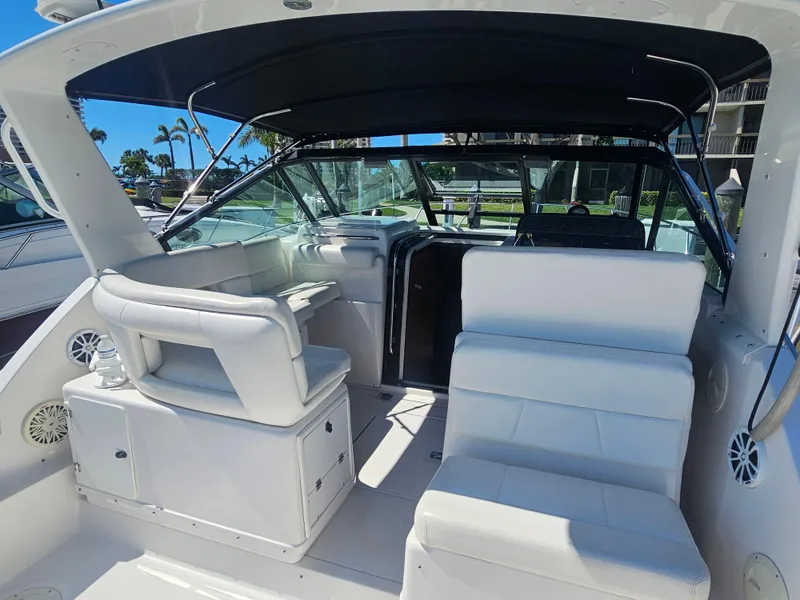 Slide: The Image of 2000 Tiara Yachts 3100 Open interior with white seating and black canopy. - 10