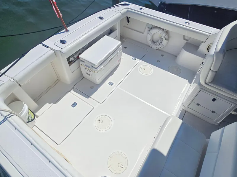 Slide: The Image of 2000 Tiara Yachts 3100 Open boat deck with seating, cooler, and life preserver. - 16