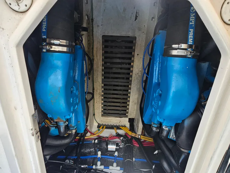 Slide: The Image of Engine compartment of a 2000 Tiara Yachts 3100 Open, featuring dual blue engines. - 17