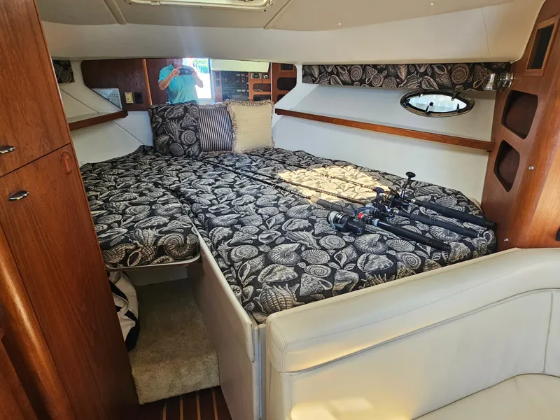Slide: The Image of Luxurious cabin interior of 2000 Tiara Yachts 3100 Open with patterned bedding. - 19