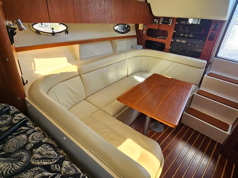 Slide: The Image of Luxurious interior of a 2000 Tiara Yachts 3100 Open with leather seating and wooden table. - 20