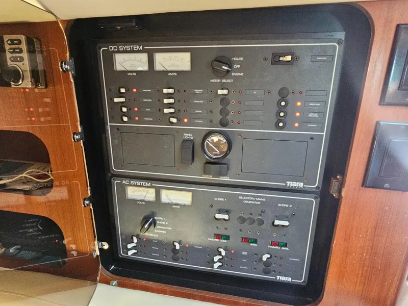 Slide: The Image of Control panel of a 2000 Tiara Yachts 3100 Open, featuring DC and AC systems. - 25