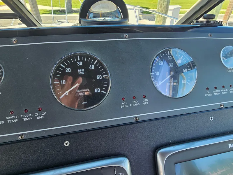 Slide: The Image of Dashboard of a 2000 Tiara Yachts 3100 Open, featuring RPM and speed gauges. - 26