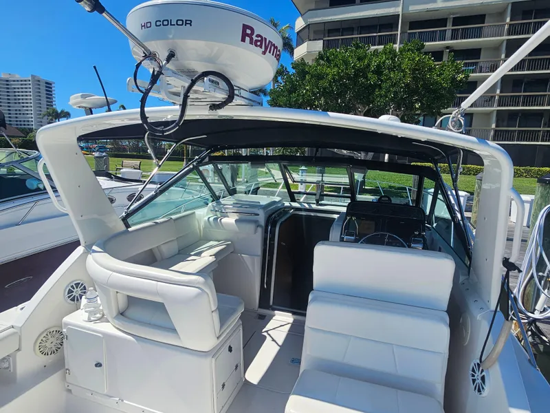 Slide: The Image of 2000 Tiara Yachts 3100 Open with white seating and Raymarine radar, docked near buildings. - 6