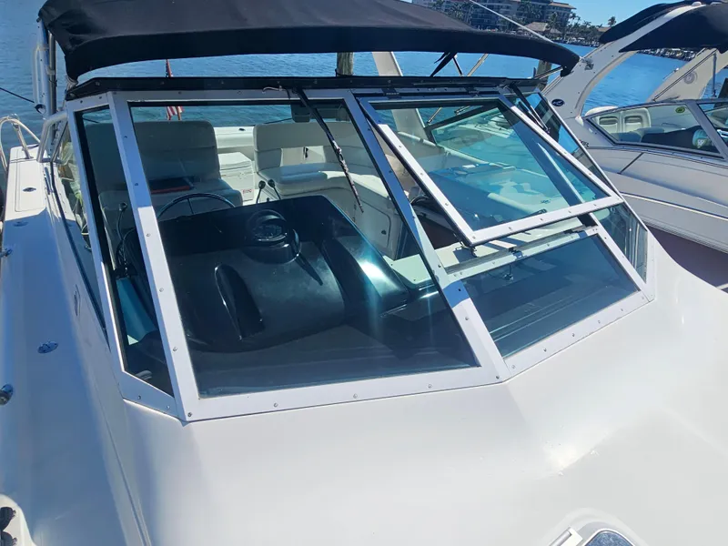 Slide: The Image of 2000 Tiara Yachts 3100 Open with black canopy, docked on a sunny day. - 7