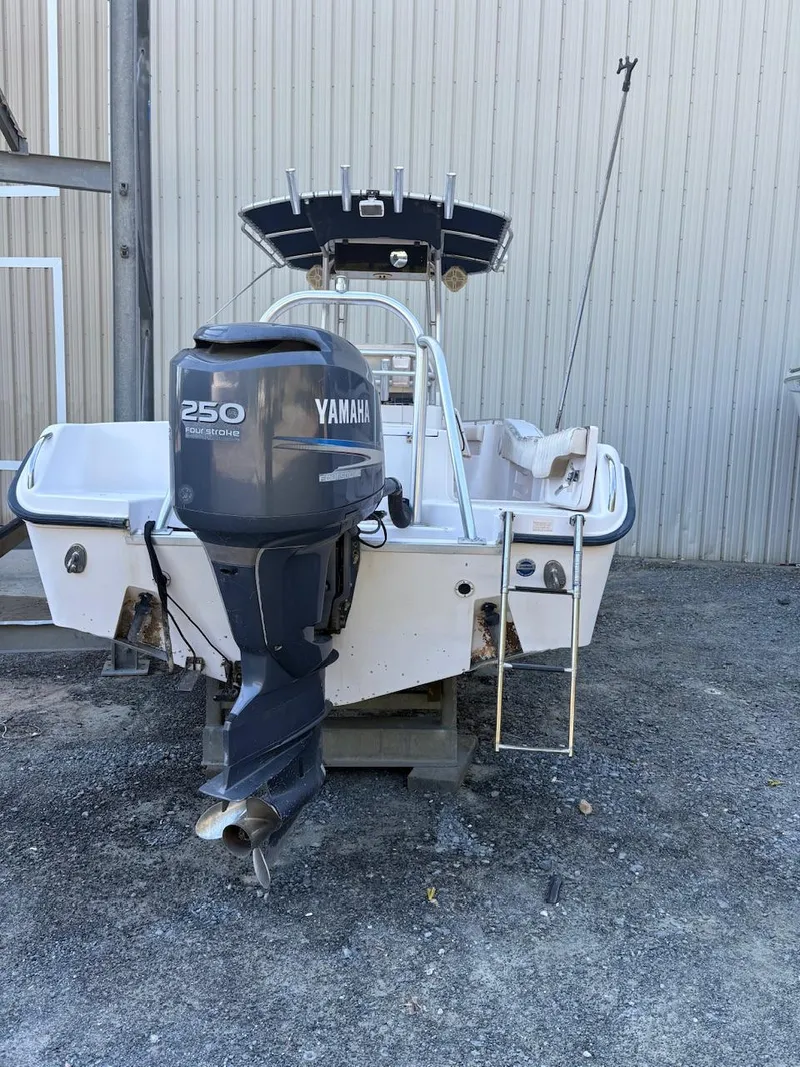 Slide: The Image of 2003 Grady-White Advance 257 boat with Yamaha 250 outboard motor, parked on gravel. - 10