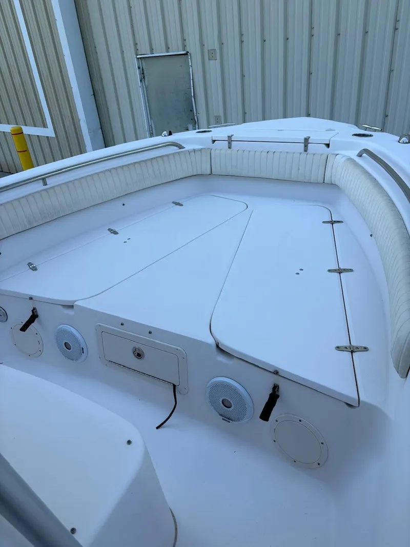 Slide: The Image of 2003 Grady-White Advance 257 boat with spacious seating and storage, docked near a building. - 6