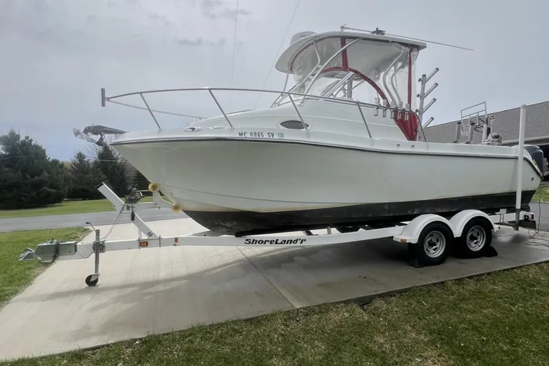 Slide: The Image of 2006 Polar 2300 Walkaround boat on ShoreLand'r trailer, parked on driveway. - 1