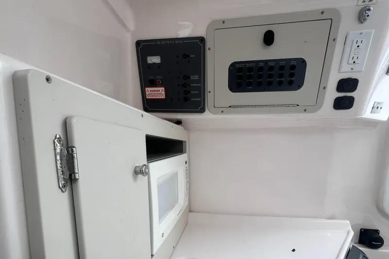 Slide: The Image of 2006 Polar 2300 Walkaround boat interior with control panel and microwave. - 10