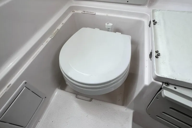 Slide: The Image of 2006 Polar 2300 Walkaround boat toilet in compact cabin space. - 11