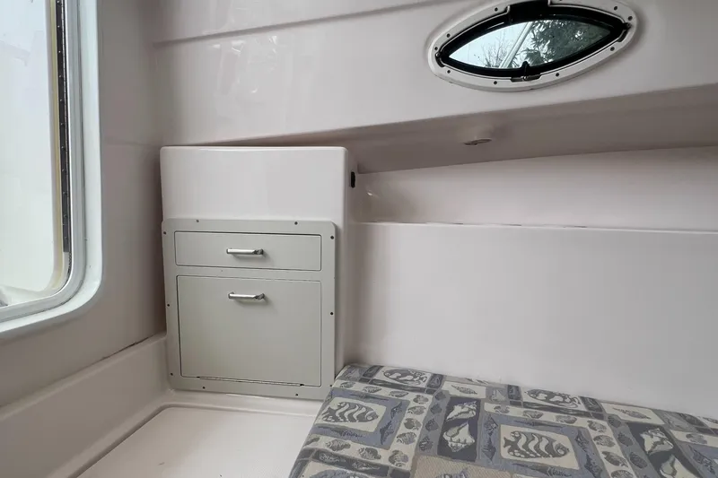 Slide: The Image of Interior of 2006 Polar 2300 Walkaround boat with storage and patterned cushion. - 12