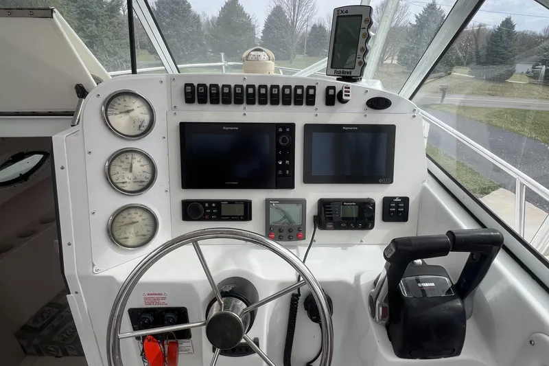 Slide: The Image of 2006 Polar 2300 Walkaround boat dashboard with gauges, steering wheel, and navigation equipment. - 7